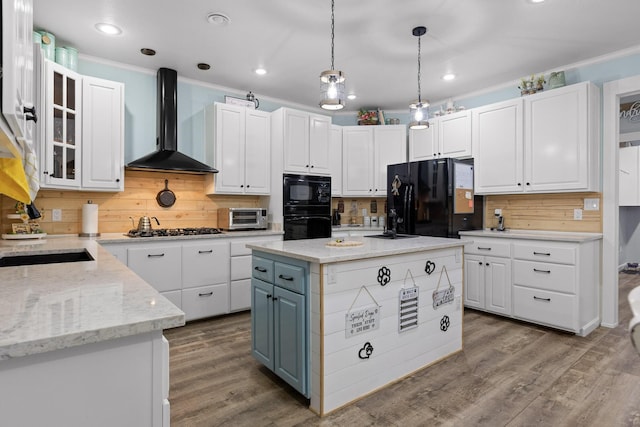 kitchen featuring white cabinetry, black appliances, wall chimney exhaust hood, and decorative backsplash