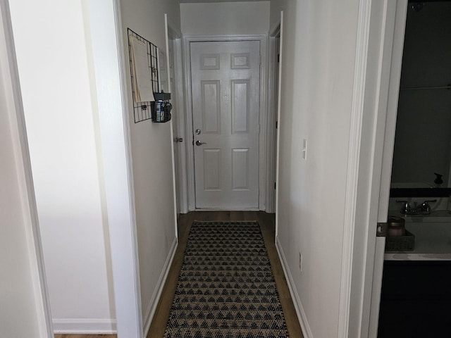 corridor featuring baseboards