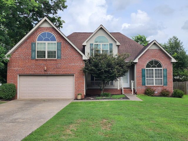 traditional home featuring brick siding, a shingled roof, concrete driveway, a front yard, and a garage