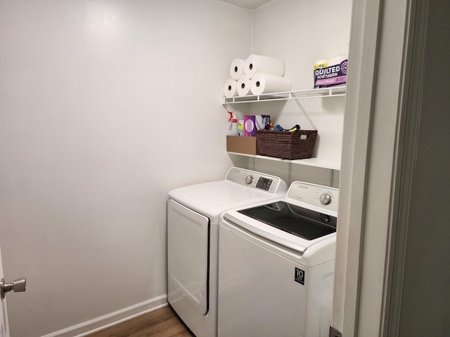 laundry area with washer and dryer, laundry area, wood finished floors, and baseboards