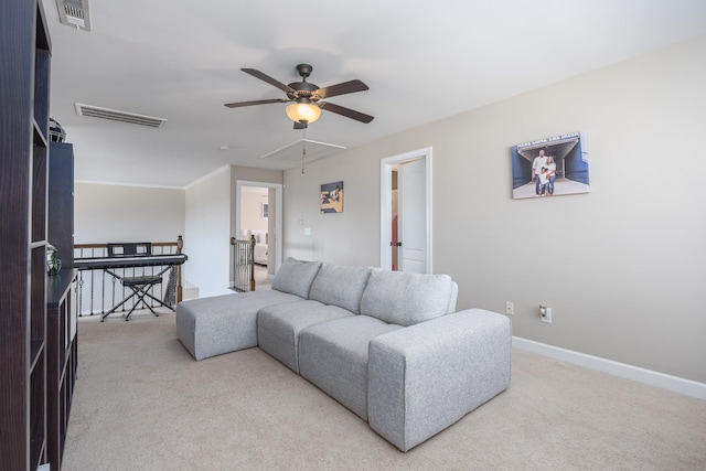 living room featuring visible vents, carpet flooring, and attic access