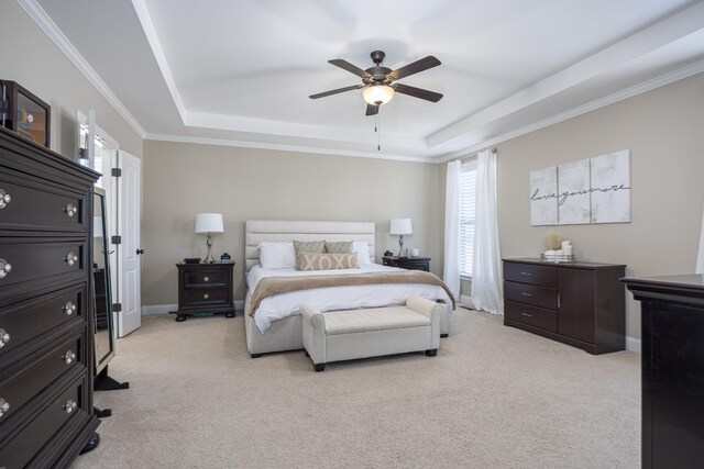 bedroom with light carpet, ceiling fan, a raised ceiling, and baseboards