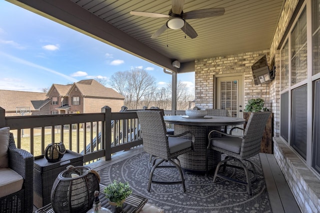 deck with outdoor dining space and a ceiling fan