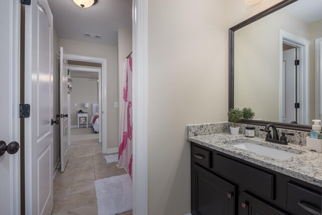 full bathroom featuring vanity, baseboards, visible vents, and tile patterned flooring