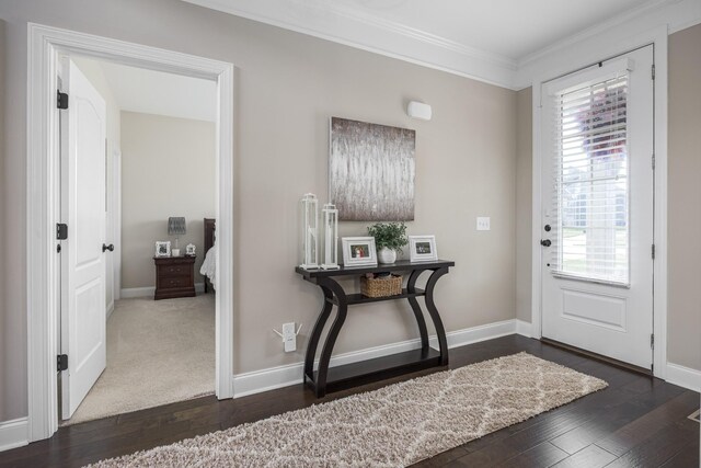 entryway featuring baseboards, crown molding, and hardwood / wood-style flooring