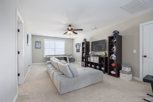 carpeted living room featuring baseboards, visible vents, and ceiling fan