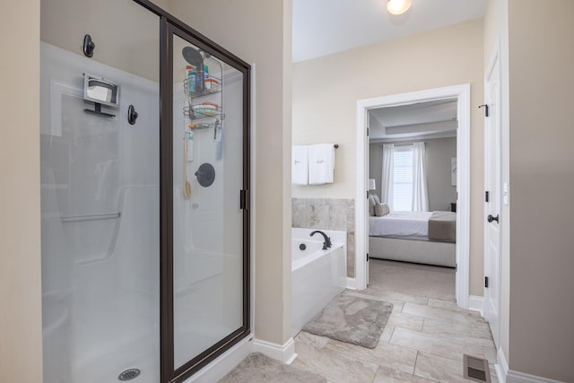 ensuite bathroom featuring visible vents, connected bathroom, a stall shower, and a garden tub