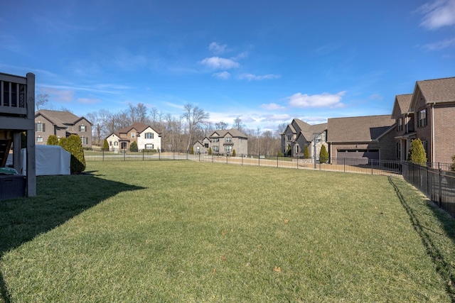 view of yard featuring fence and a residential view