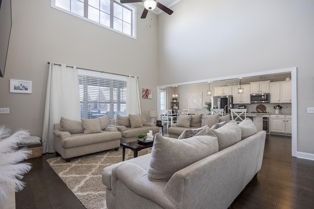 living room featuring ceiling fan, baseboards, beverage cooler, and dark wood finished floors