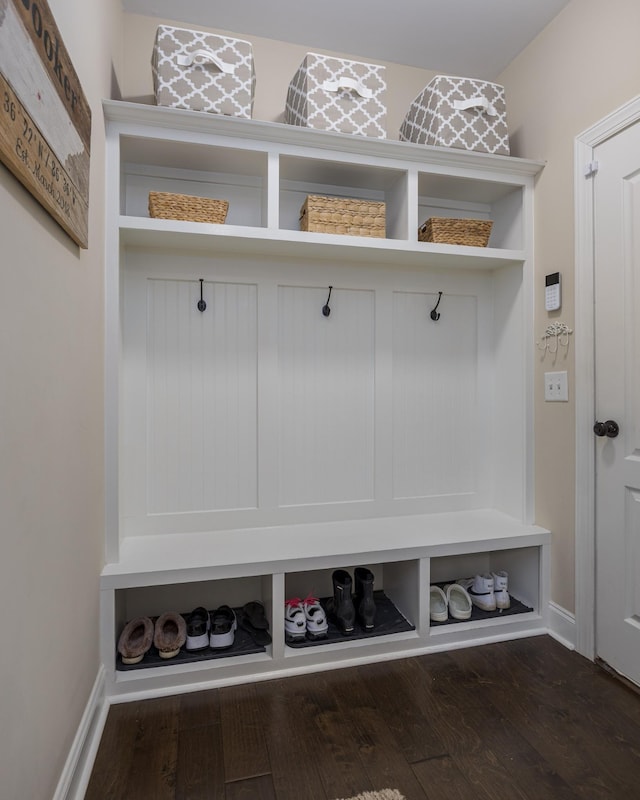 mudroom featuring wood finished floors and baseboards