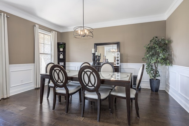 dining room with an inviting chandelier, dark wood finished floors, wainscoting, and ornamental molding