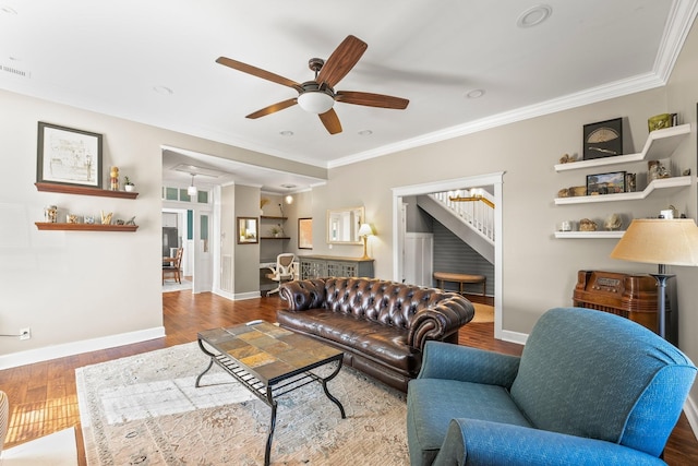 living area featuring baseboards, wood finished floors, a ceiling fan, and ornamental molding