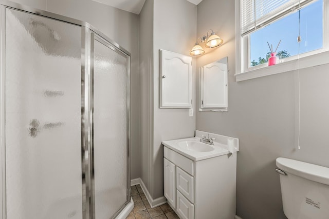 full bath with toilet, a stall shower, tile patterned flooring, baseboards, and vanity