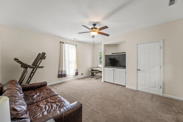 carpeted living area featuring visible vents, a ceiling fan, and baseboards