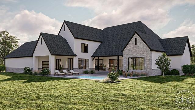 rear view of property featuring a yard, stone siding, and a patio area