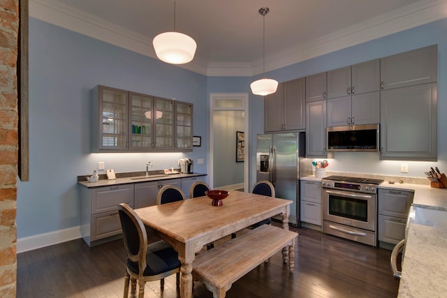 dining space featuring crown molding, baseboards, dark wood-style flooring, and washer / dryer