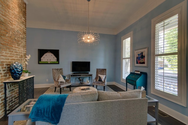 living room with dark wood-type flooring, baseboards, crown molding, and an inviting chandelier