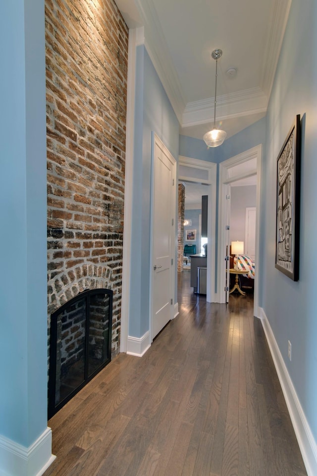 corridor with baseboards, dark wood-style flooring, and crown molding