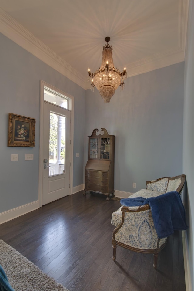 foyer entrance with hardwood / wood-style floors, a notable chandelier, baseboards, and ornamental molding