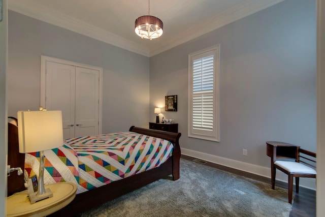 bedroom with a closet, baseboards, and crown molding