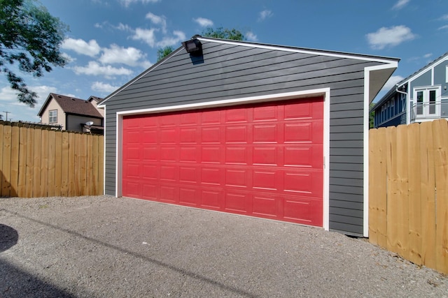 detached garage featuring fence