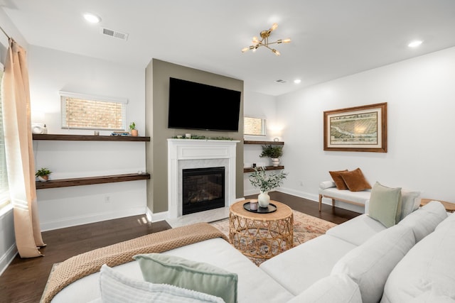 living area with visible vents, wood finished floors, recessed lighting, a premium fireplace, and baseboards