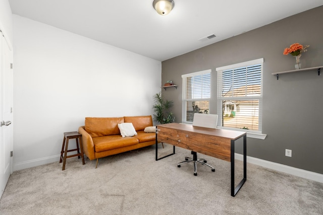 carpeted office space featuring visible vents and baseboards