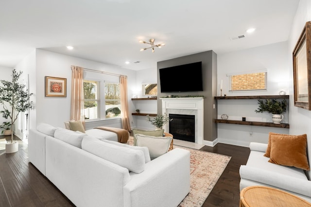 living area with visible vents, baseboards, dark wood finished floors, recessed lighting, and a fireplace