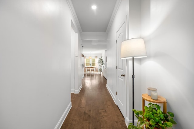 hallway featuring recessed lighting, baseboards, dark wood-style flooring, and crown molding