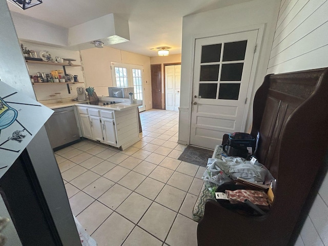 kitchen with black electric stovetop, dishwasher, light countertops, light tile patterned floors, and open shelves