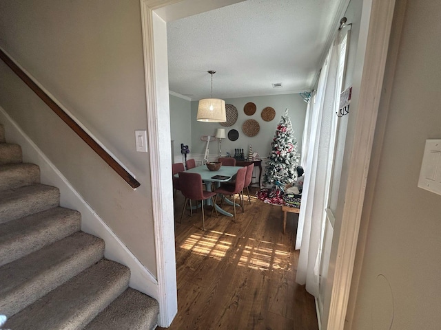 interior space featuring wood finished floors and ornamental molding