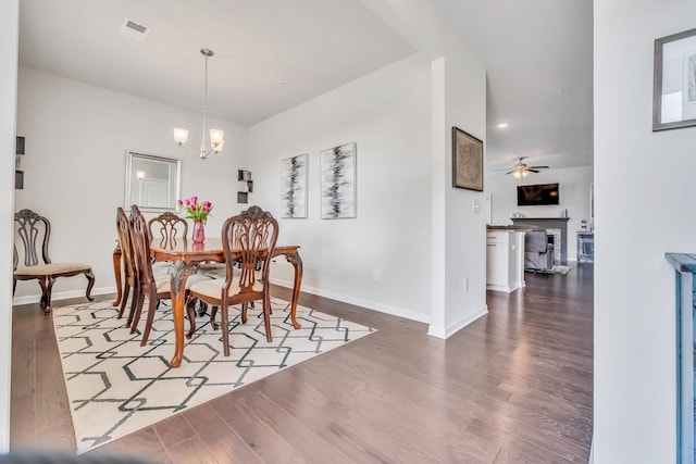 dining space with visible vents, baseboards, and wood finished floors