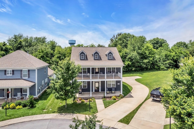 view of front of house with a balcony, a porch, and a front lawn