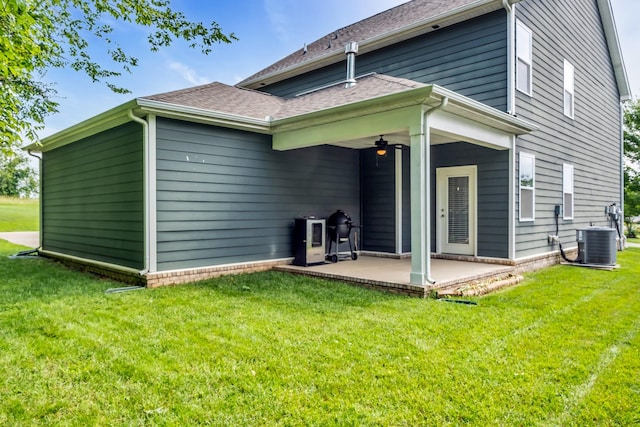 rear view of house featuring a patio area, central AC unit, a yard, and a ceiling fan