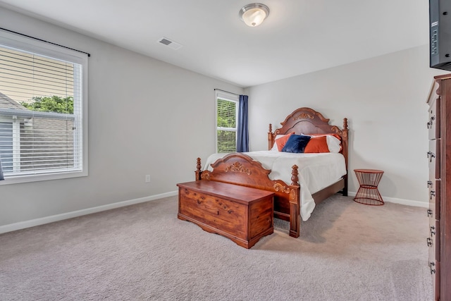 bedroom featuring visible vents, baseboards, and carpet flooring