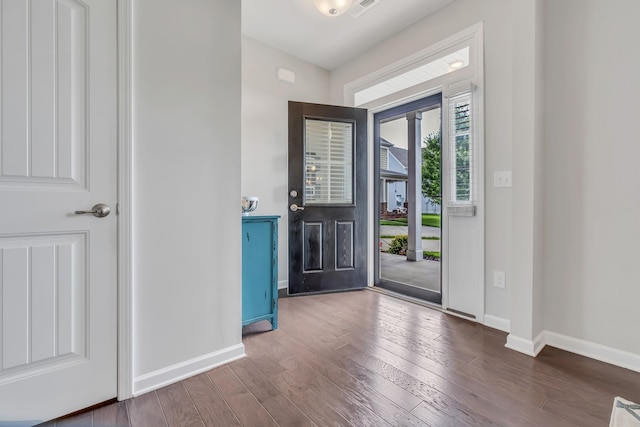 entryway featuring visible vents, baseboards, and wood finished floors