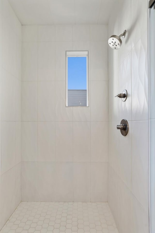 bathroom with a tile shower