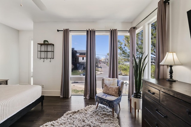 bedroom with baseboards and dark wood-style floors