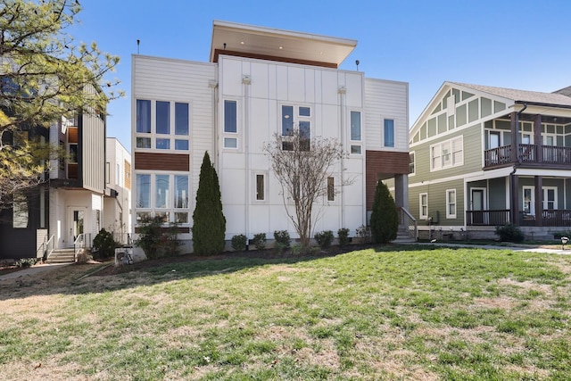 rear view of property featuring a yard