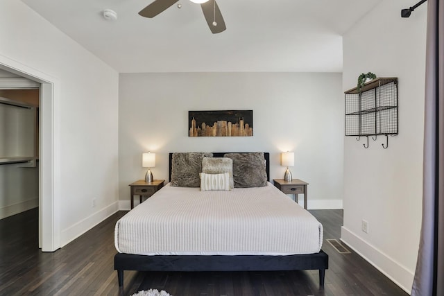 bedroom featuring a ceiling fan, baseboards, and wood finished floors