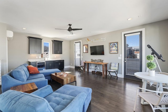 living room with a wall unit AC, beverage cooler, dark wood-style flooring, and a wealth of natural light