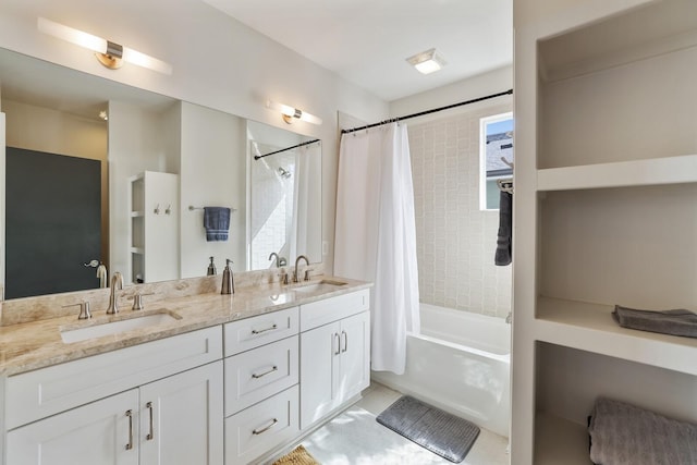 bathroom with double vanity, shower / bath combo with shower curtain, and a sink