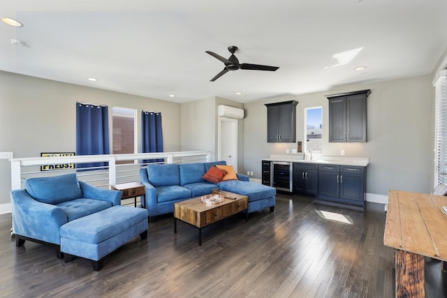 living area featuring beverage cooler, baseboards, recessed lighting, dark wood-type flooring, and a wall mounted air conditioner