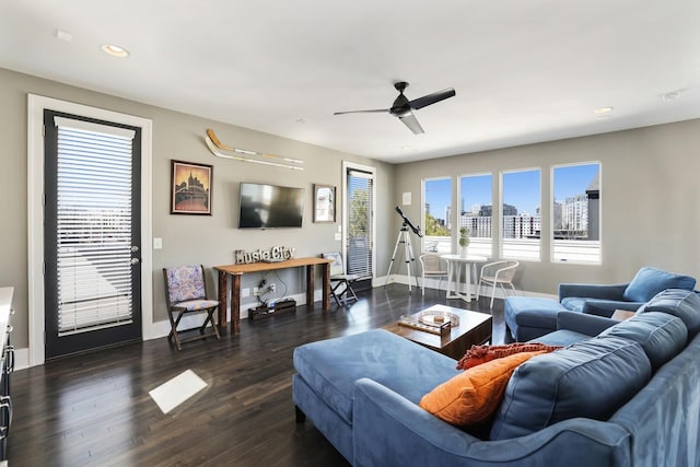 living area with dark wood finished floors, recessed lighting, a ceiling fan, and baseboards