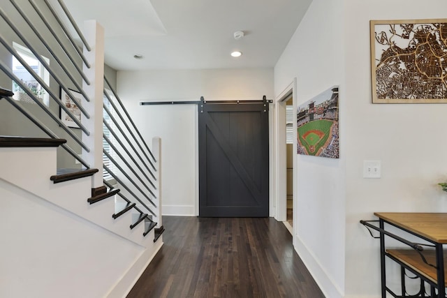 entryway with stairway, baseboards, recessed lighting, dark wood-style flooring, and a barn door