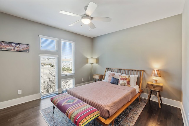 bedroom with ceiling fan, baseboards, and wood finished floors