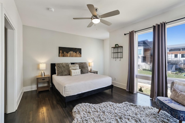 bedroom featuring a ceiling fan, access to exterior, wood finished floors, and baseboards