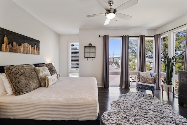 bedroom featuring baseboards, dark wood-style floors, and a ceiling fan