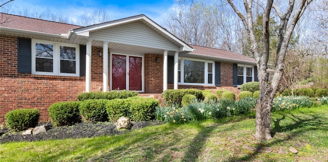 ranch-style house featuring brick siding