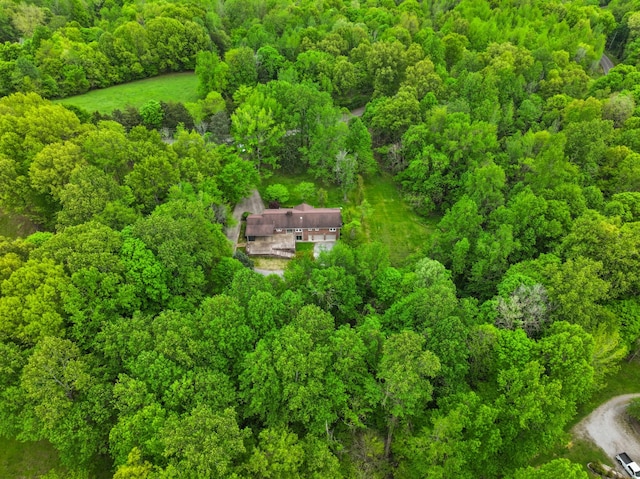 bird's eye view with a wooded view